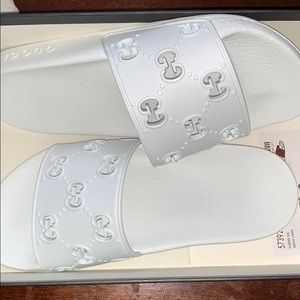 All white Gucci slides